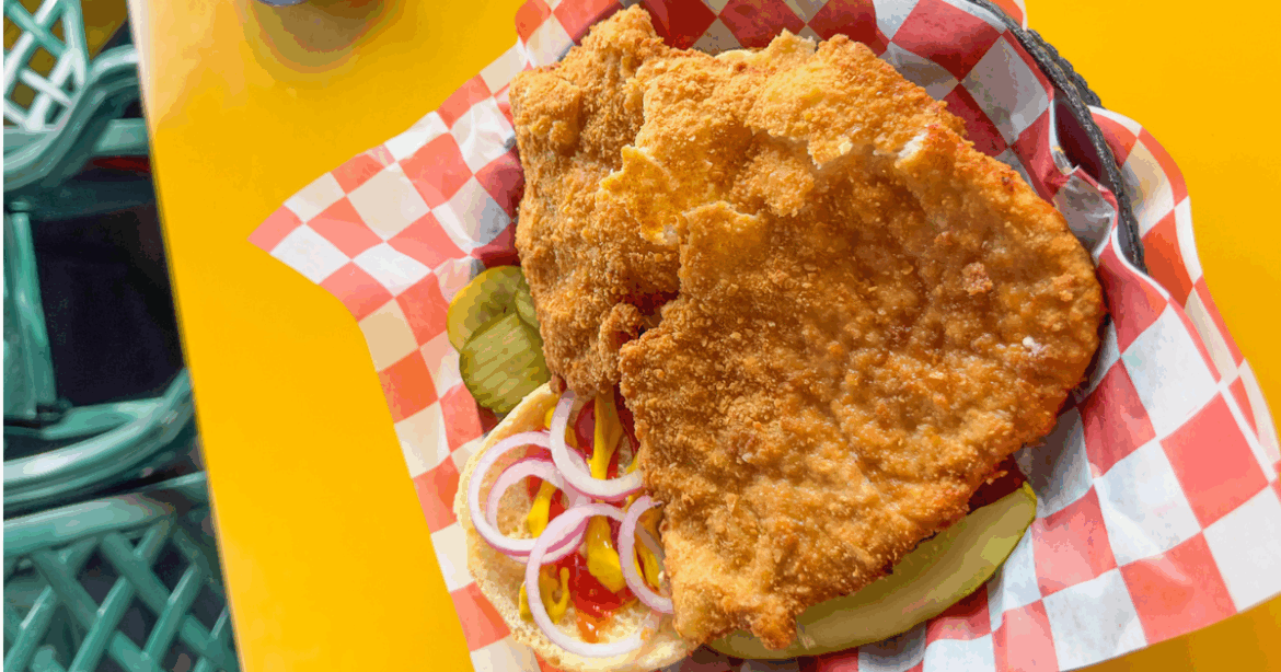Goldie’s Ice Cream Shoppe Boasts Iowa’s Best Tenderloin Sandwich A bison calf standing next to a mother bison with a herd of bison in the background.