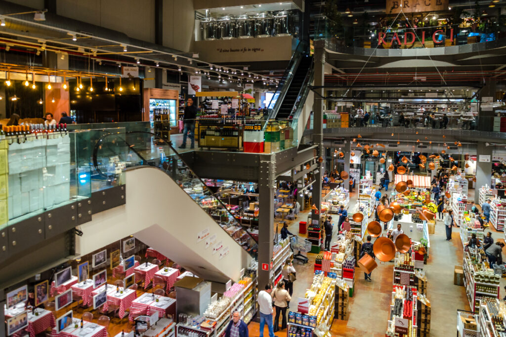 Image shows the interior of Eataly Italian food hall and market.