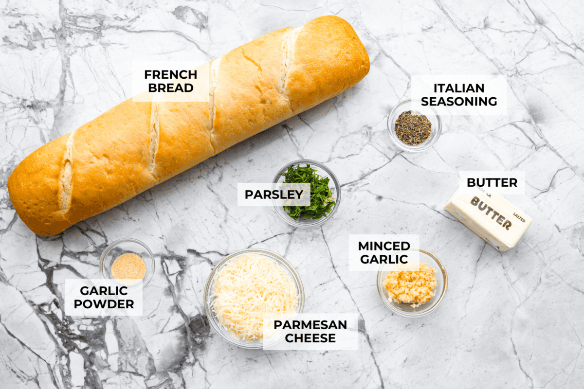 I’m not saying I’ve eaten half a loaf of this Garlic Bread straight off the baking sheet…but I’m also not not saying that. It’s golden, cheesy, dripping with garlicky butter, and so good! Overhead shot of labeled ingredients.