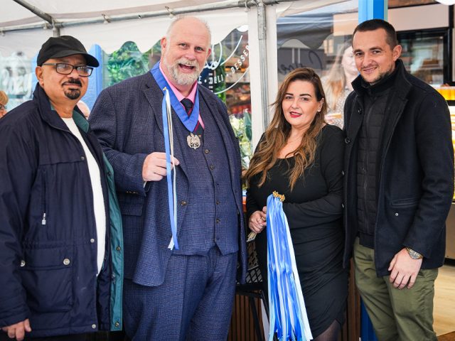 Mayor Tom Wootton with Sandy Christou to his left at the opening of Cozy, her new Greek deli on Castle Road. Image: Cozy