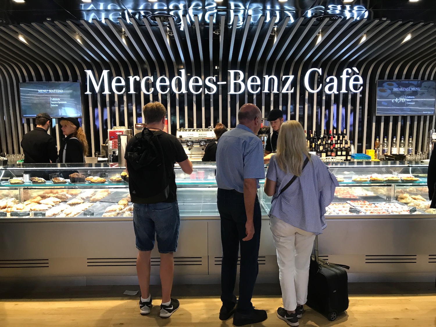 a group of people standing in front of a display