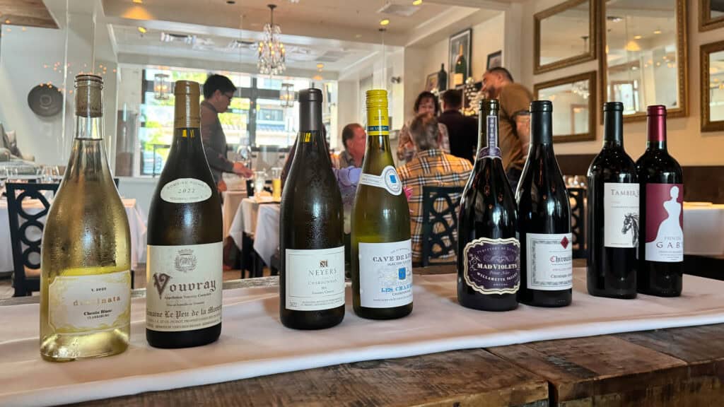 four pairs of wine side by side on a long table