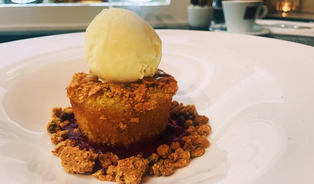 a piece of cake. topped with ice cream on plate