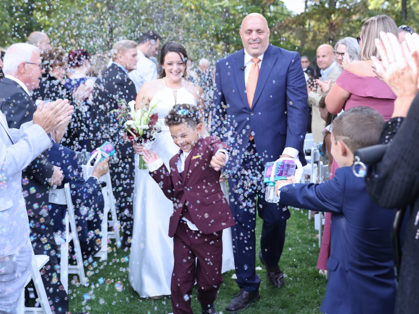 Maria's son, Nico (center), served as ring bearer and walked with the couple down the aisle after the ceremony to Tina Turner's "Simply the Best."