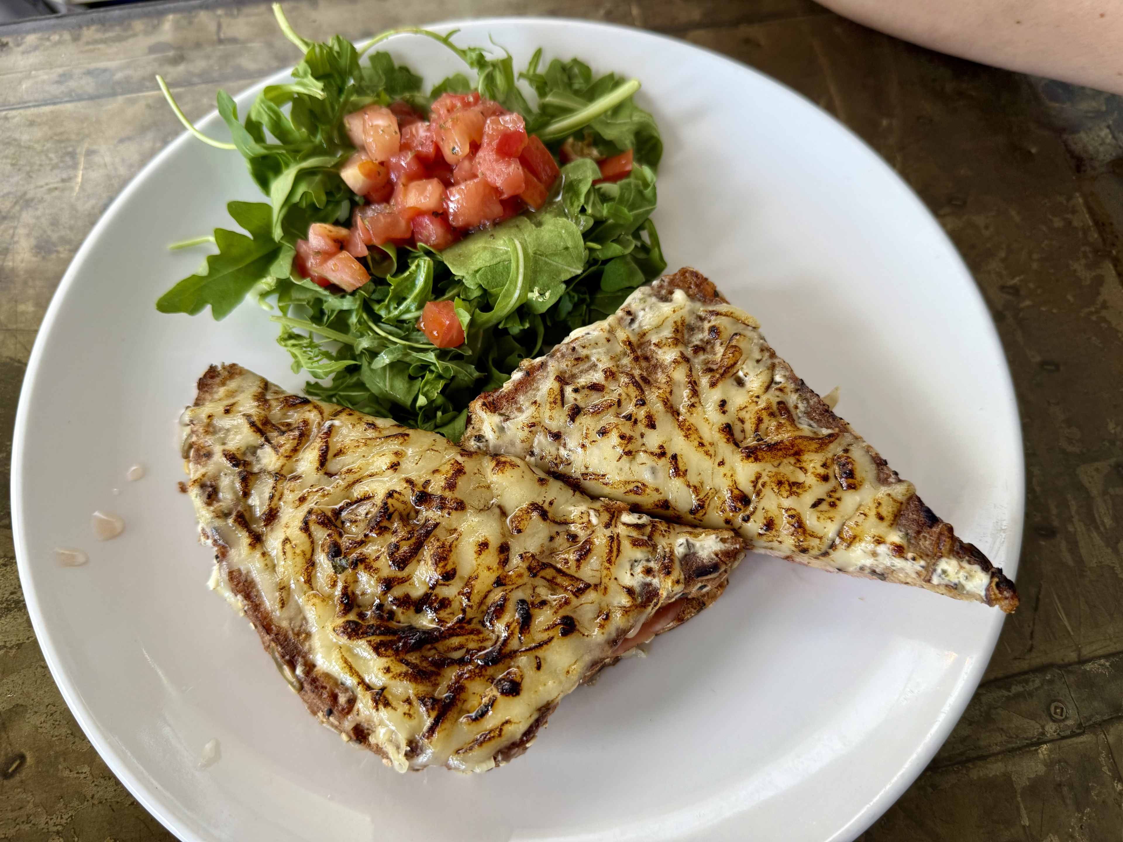 A sandwich with a side salad.