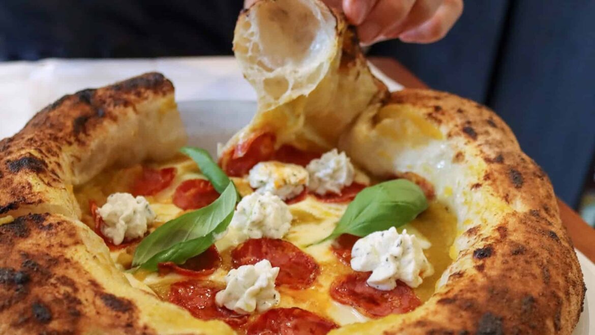 Piccolo Buco is opening a new restaurant in Tampa A large fluffy crust of a pizza from Piccolo Buco topped with dollops of cheese, pepperoni and basil