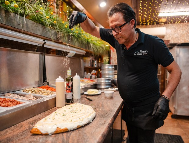 Owner Alfi Picone garnishes a German stromboli at La Dolce...