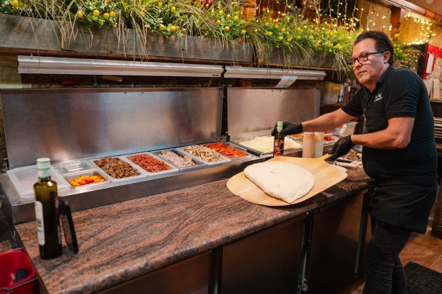 Owner Alfi Picone prepares German stromboli for a Facebook video...