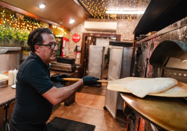 Owner Alfi Picone places a German stromboli in the oven...