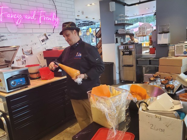 Award-winning chef Romuald Guiot, 48, works on cruffins, or muffin...