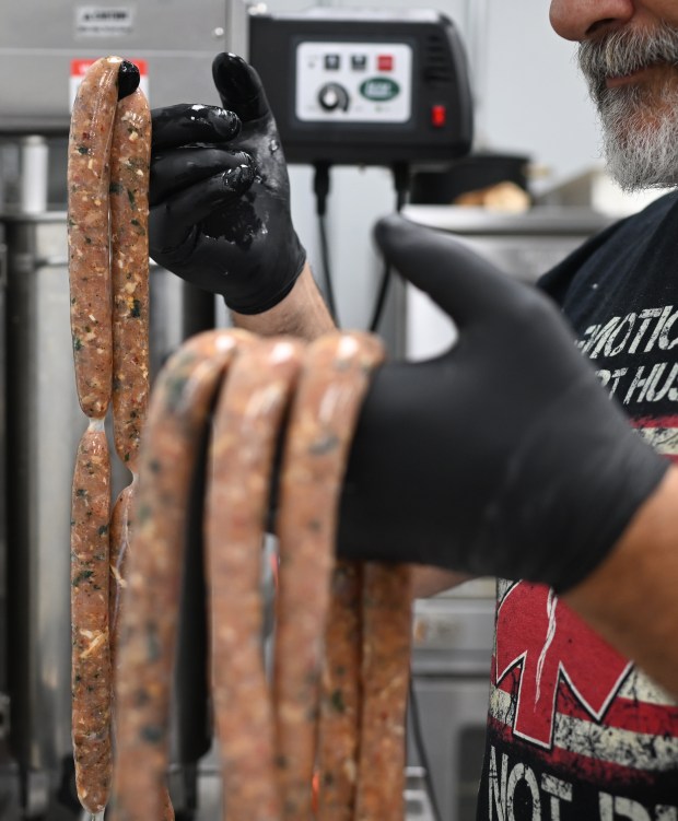 Co-owner Christophe Goudy makes spicy chicken sausages at Goudy's Deli and Market in Denver on June 26, 2025. (Photo by RJ Sangosti/The Denver Post)