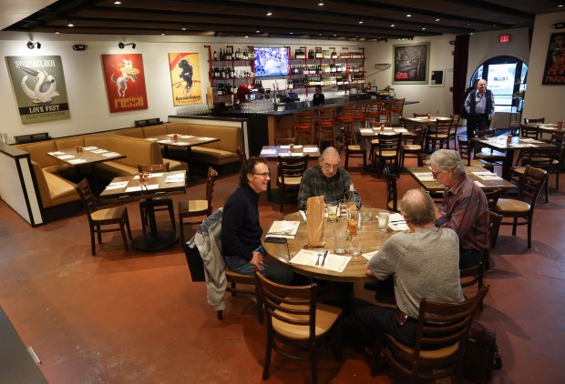 Guests sit at a table during lunch at Rosso Pizzeria...