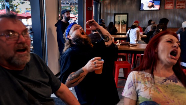At Old Caz Beer in Rohnert Park chef Bradley Wildridge, middle, reacts with Karen Durando, right, and John Gasquet of Rohnert Park, Thursday, Oct. 2, 2025, during a watch party for season 24 episode of Hell's Kitchen, in which Wildridge is competing in. (Kent Porter / The Press Democrat)