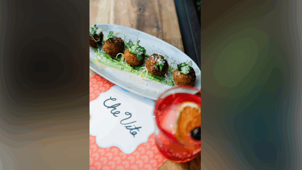 Plate of arancini croquettes with lemon pesto aioli and microgreens at Che Vita Tampa