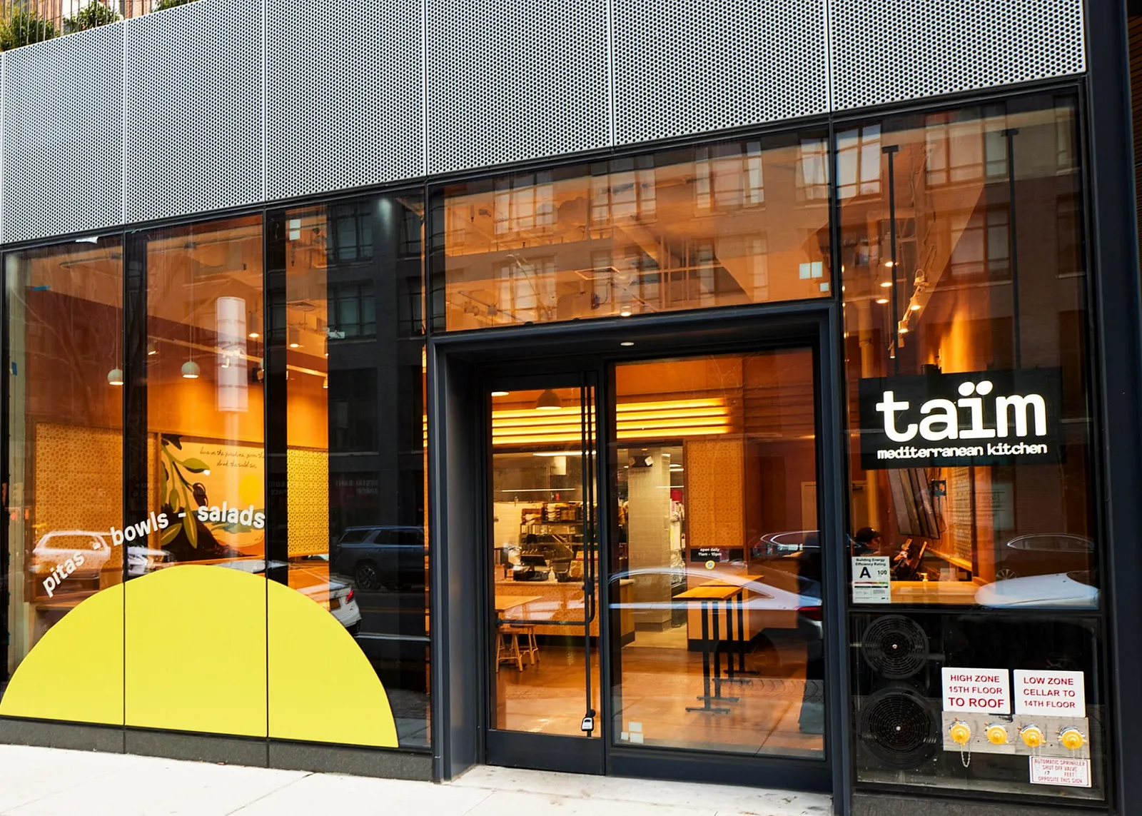 An exterior photo of a Taim restaurant.
