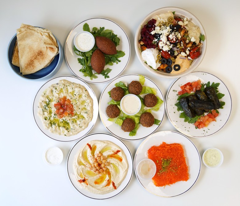 Various dishes at Zakee Mediterranean Street Food in Akron's Merriman Valley. Top row (left to right): Pita bread, kibbeh, Zakee bowl Middle row (left to right): Baba ghanoush, falafel, grape leaves Bottom row (left to right): Hummus, kenafeh.