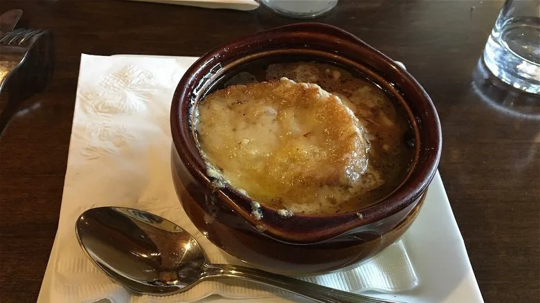 bowl of French onion soup on table at Left Bank Cafe