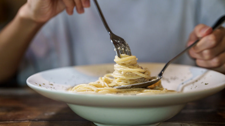 Person spinning spaghetti around their fork