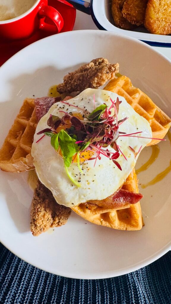 Eggs, waffles, bacon and crispy tenders with maple syrup and a shake. An indulgent but enjoyable breakfast today.