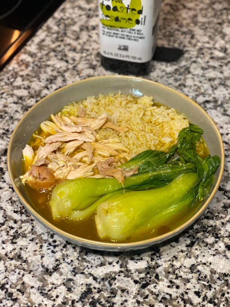 Shredded rotisserie chicken, bok choy, and basmati rice in a ginger garlic scallion broth