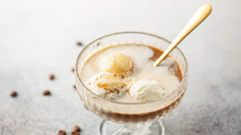 Vanilla ice cream and espresso Affogato with a spoon in a coupe glass