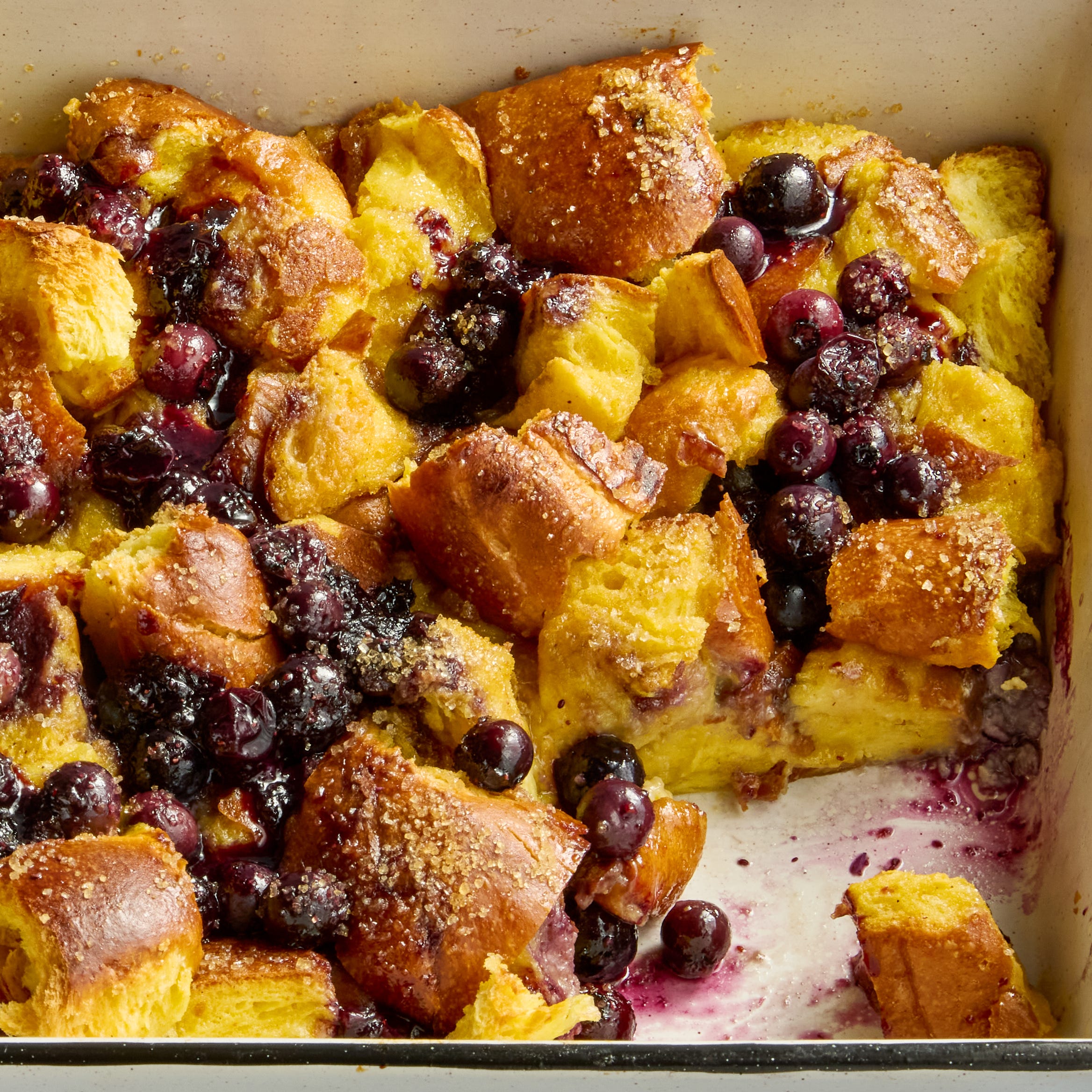 french toast casserole in a pan with blueberries