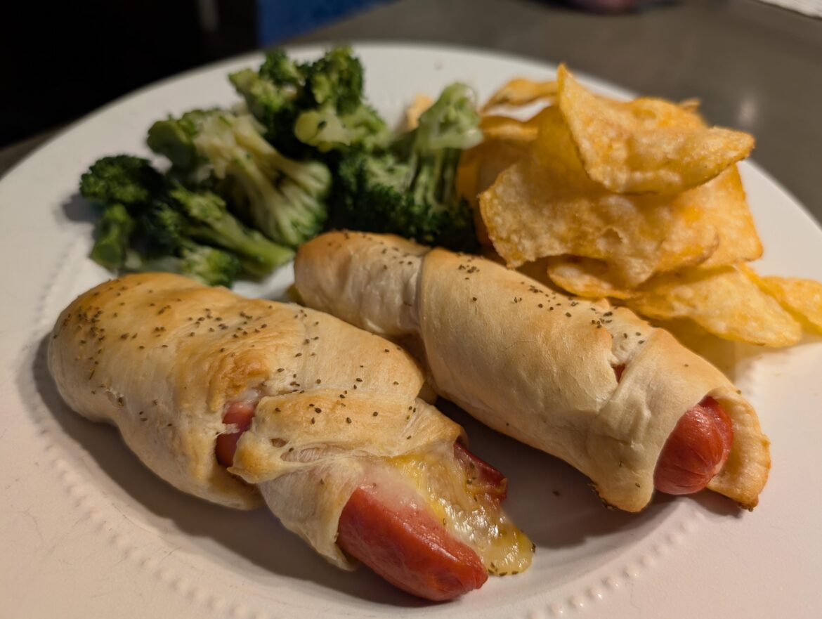 Crescent dough wrapped hot dogs with cheese, broccoli and Voodoo chips