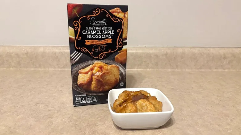 Caramel apple blossoms in a bowl and box on neutral background.
