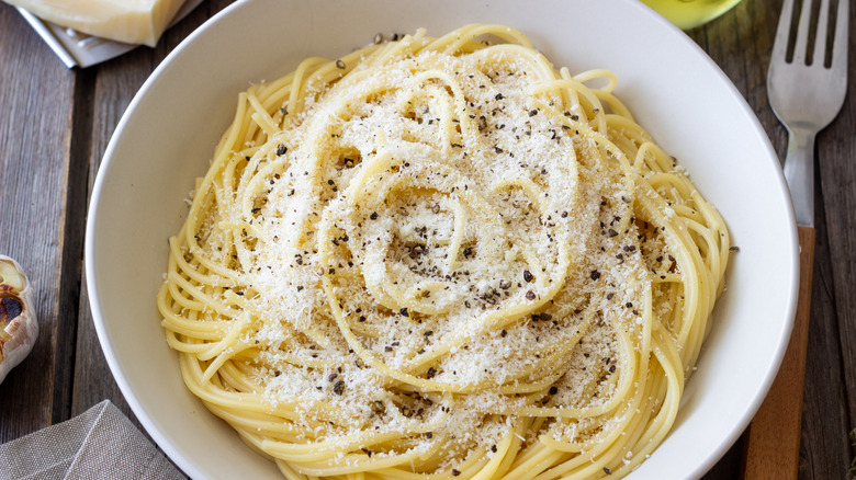 Spaghetti cacio e pepe served in a white bowl