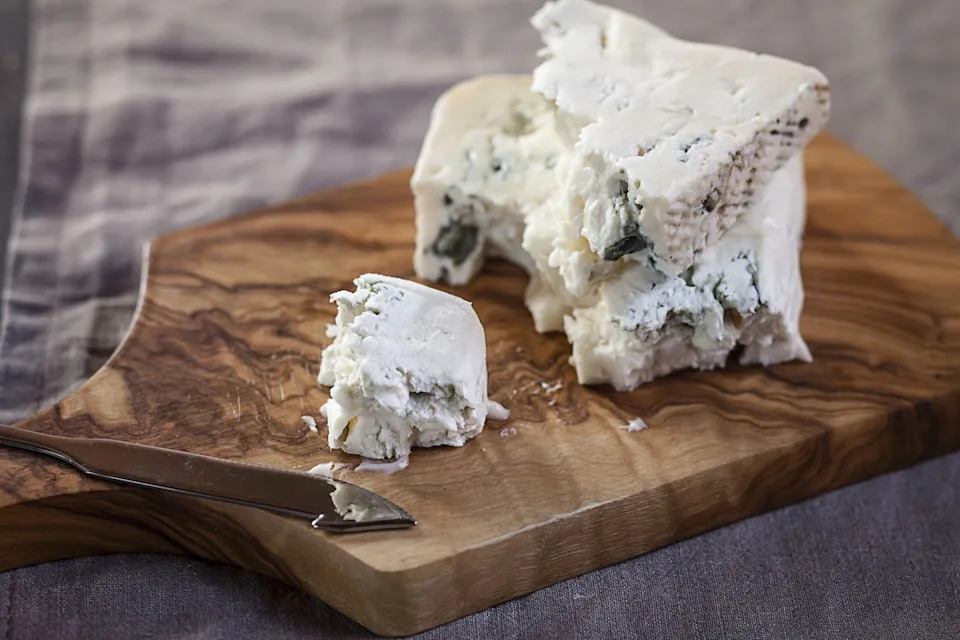 pieces of gorgonzola cheese on chopping board
