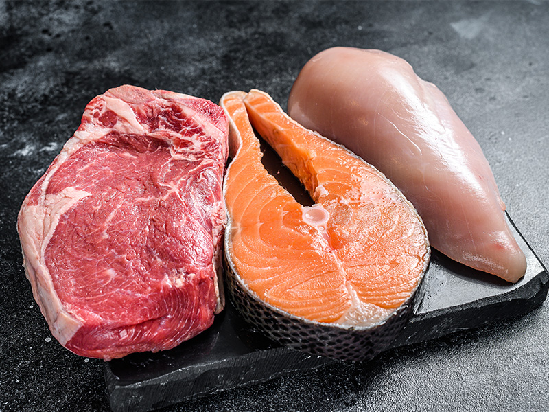 The carnivore diet: why it’s not good for your health Raw meat, salmon and chicken on a table.