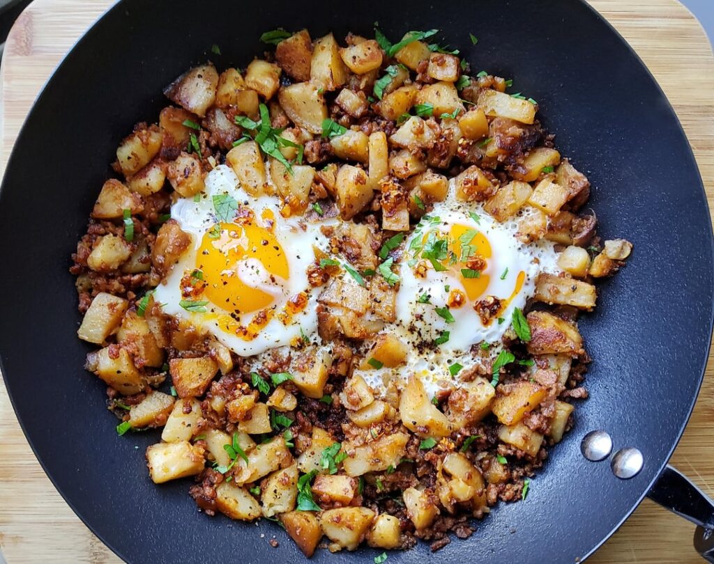 Two baked potatoes diced and cooked with sausage to make a great breakfast skillet.