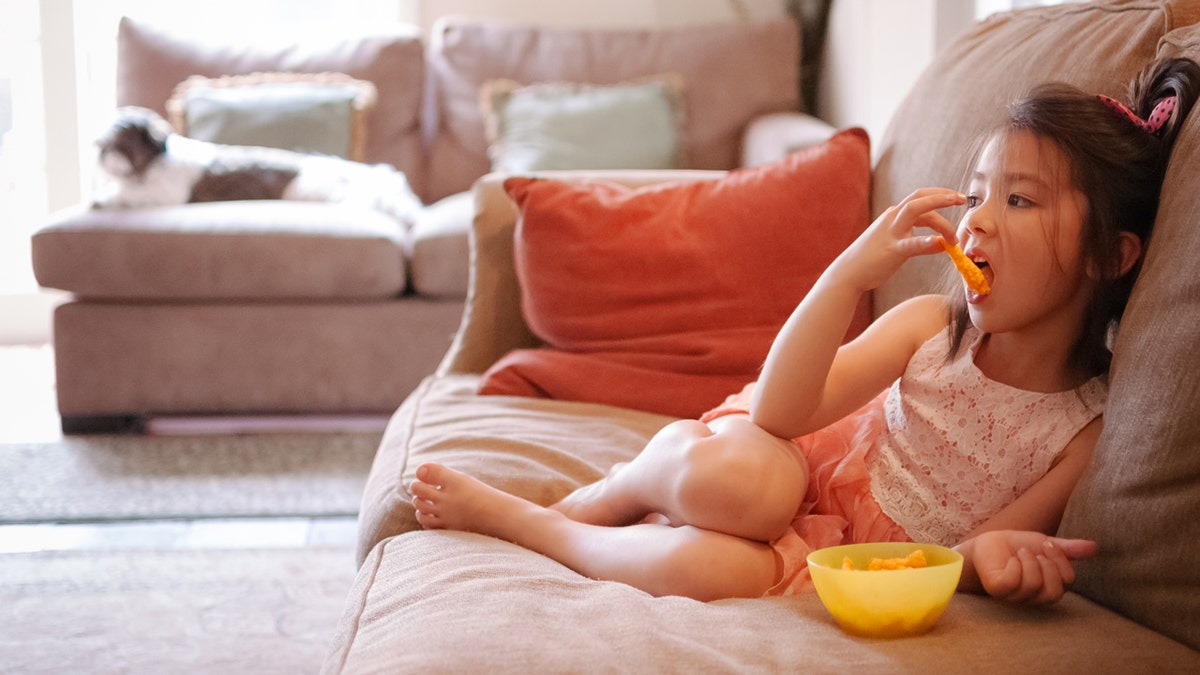 girl eating cheetos