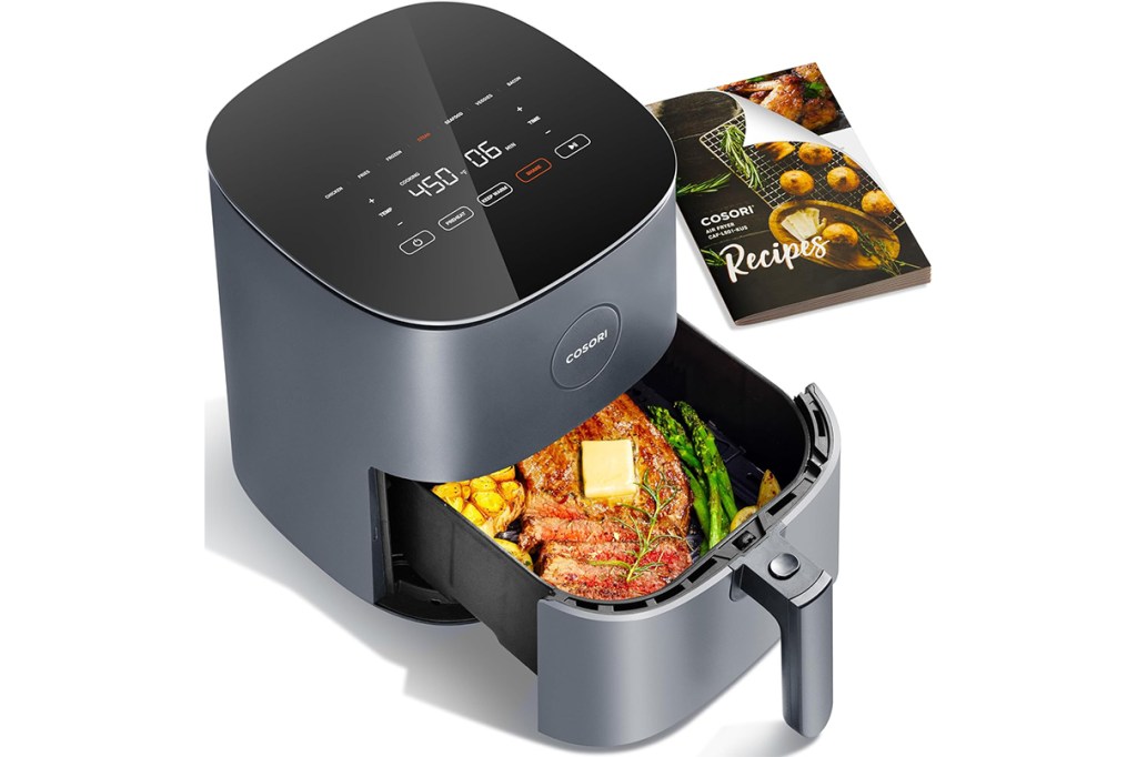 Black air fryer with food inside