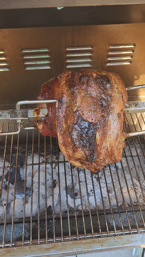 charcoal rotisserie chicken and pork shoulder