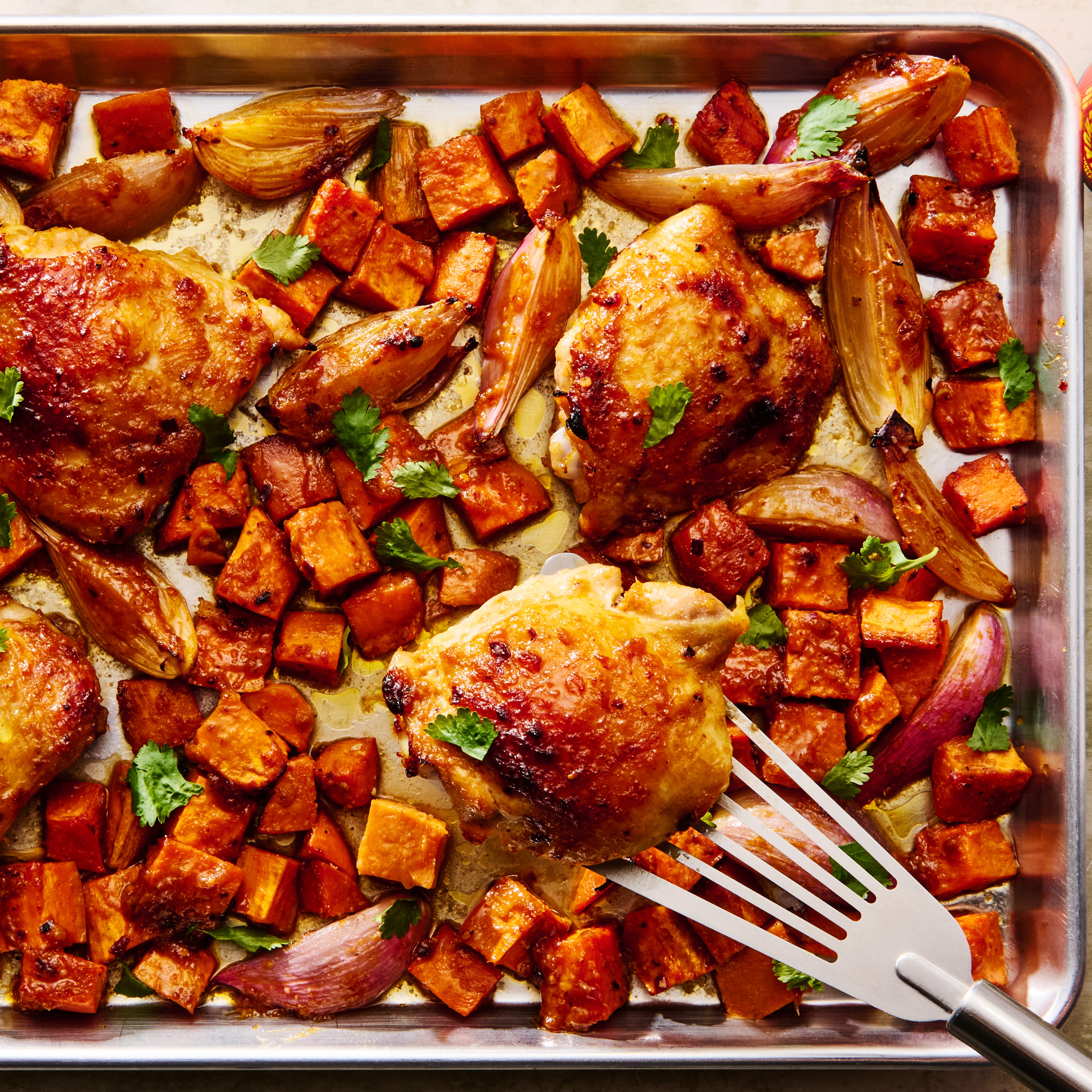 bone in chicken thighs, sweet potatoes, and shallots get smothered with miso chili sauce and baked until the sweet potatoes are tender and caramelized and the chicken is juicy and golden brown