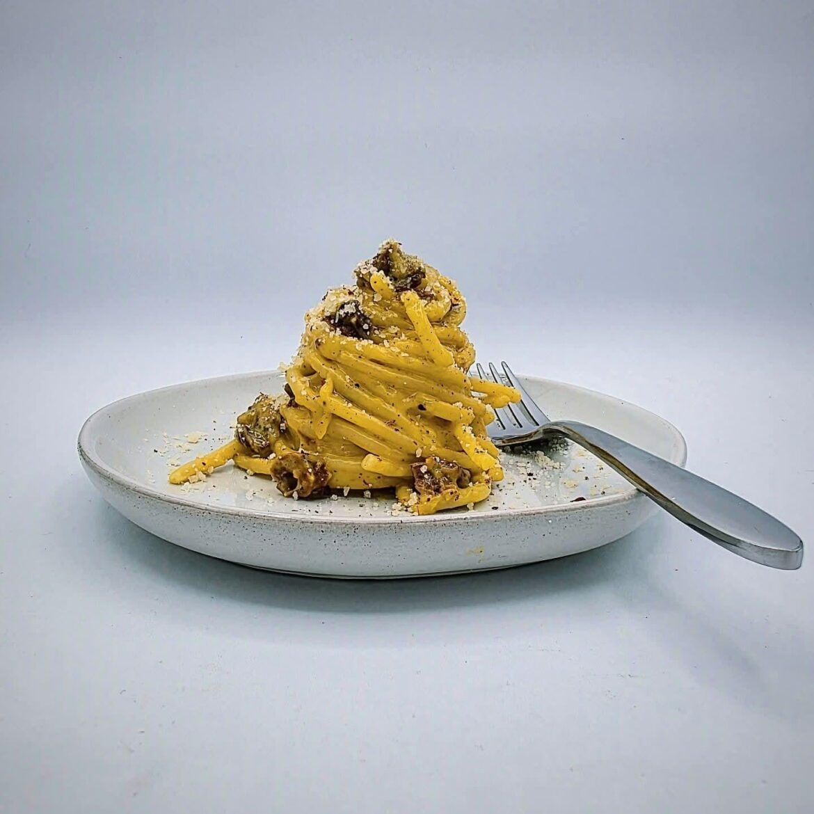 Turkey egg carbonara with chanterelle "guanciale", bronze cut bucatini, toasted kampot black pepper, first cold press Italian olive oil, and Pecorino Romano