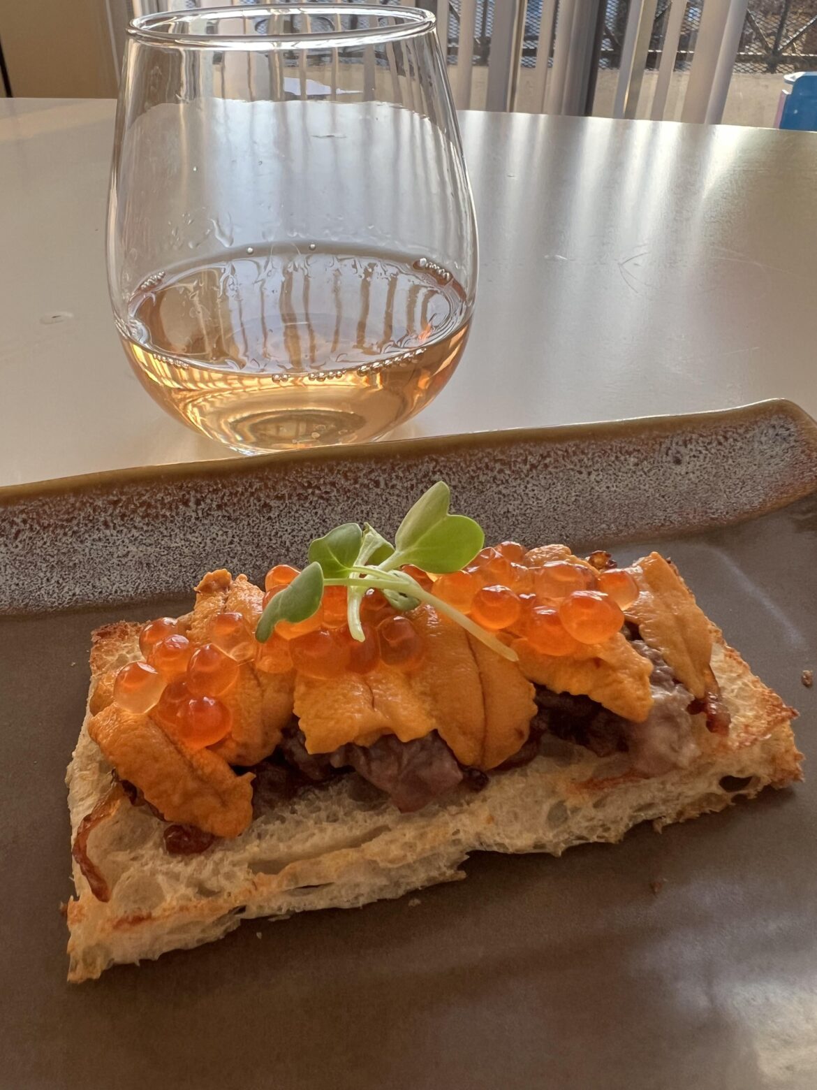 I call this indulgent toast: homemade sour dough, onion jam, roasted bone marrow, uni, and salmon roe.