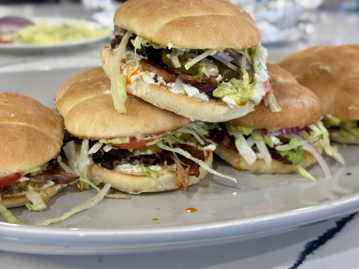 Al pastor Tortas on a fresh baked telera roll. Includes a grilled onion and cilantro aioli.