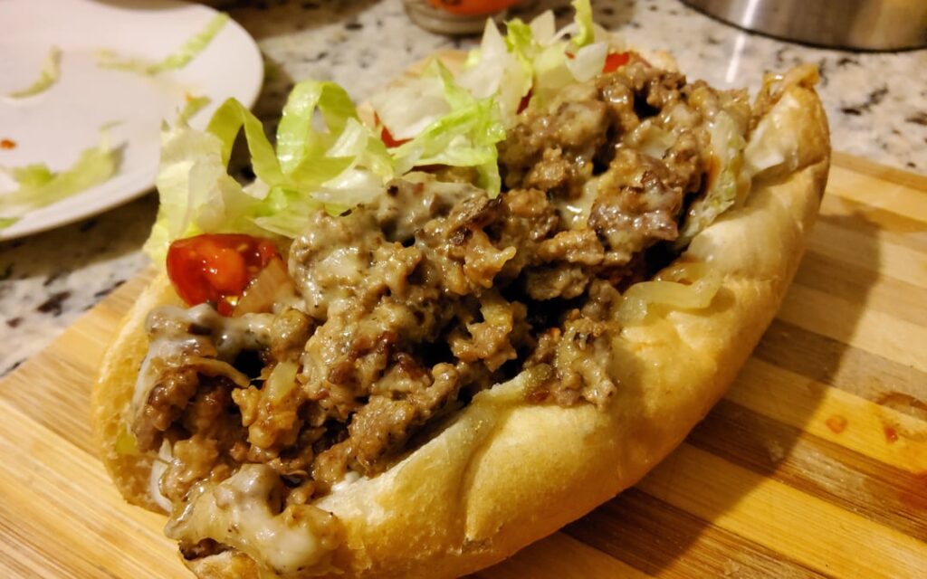 Chopped cheese with onions and American cheese on a hoagie roll.