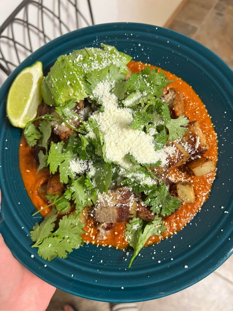 Pork Belly and Potatoes over a red chili sauce.