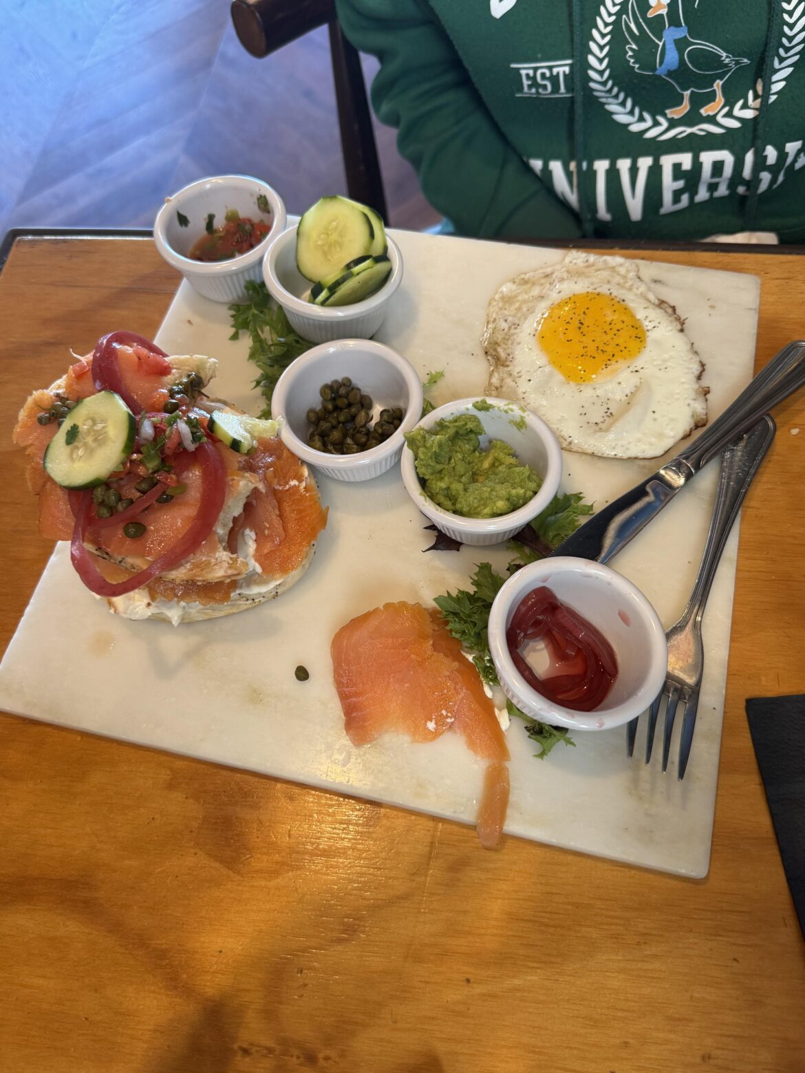 Smoked salmon bagel brought out on a slab of marble.