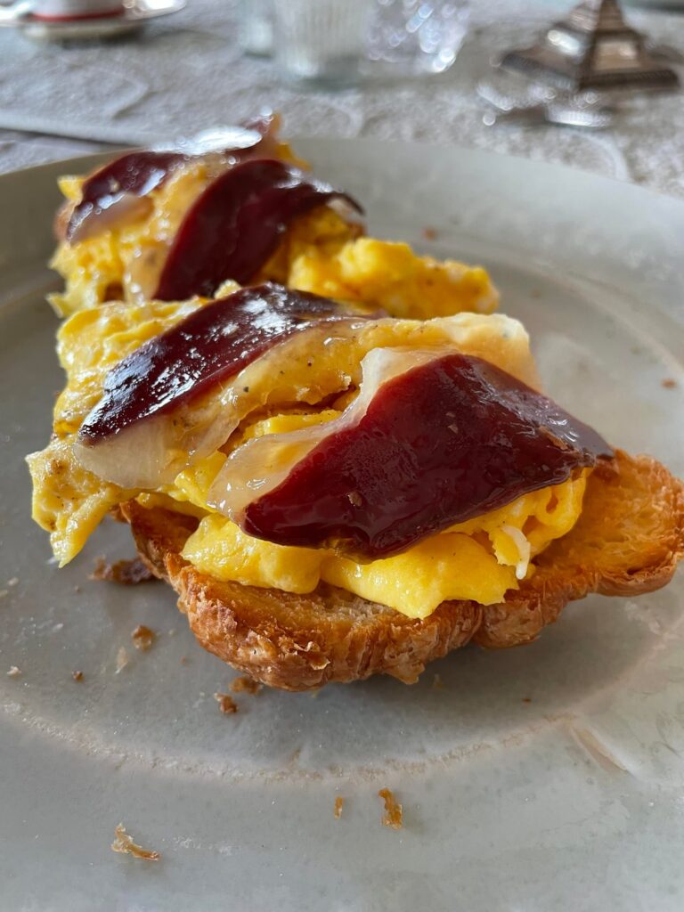 Duck prosciutto + scrambled eggs with cheese on Hero croissant