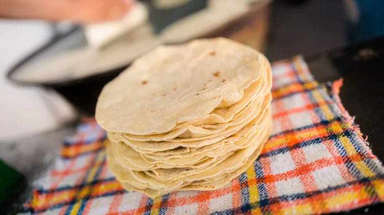 a stack of freshly made corn tortillas