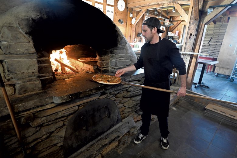 Willis Schenk baking flatbreads in a wood-fired oven