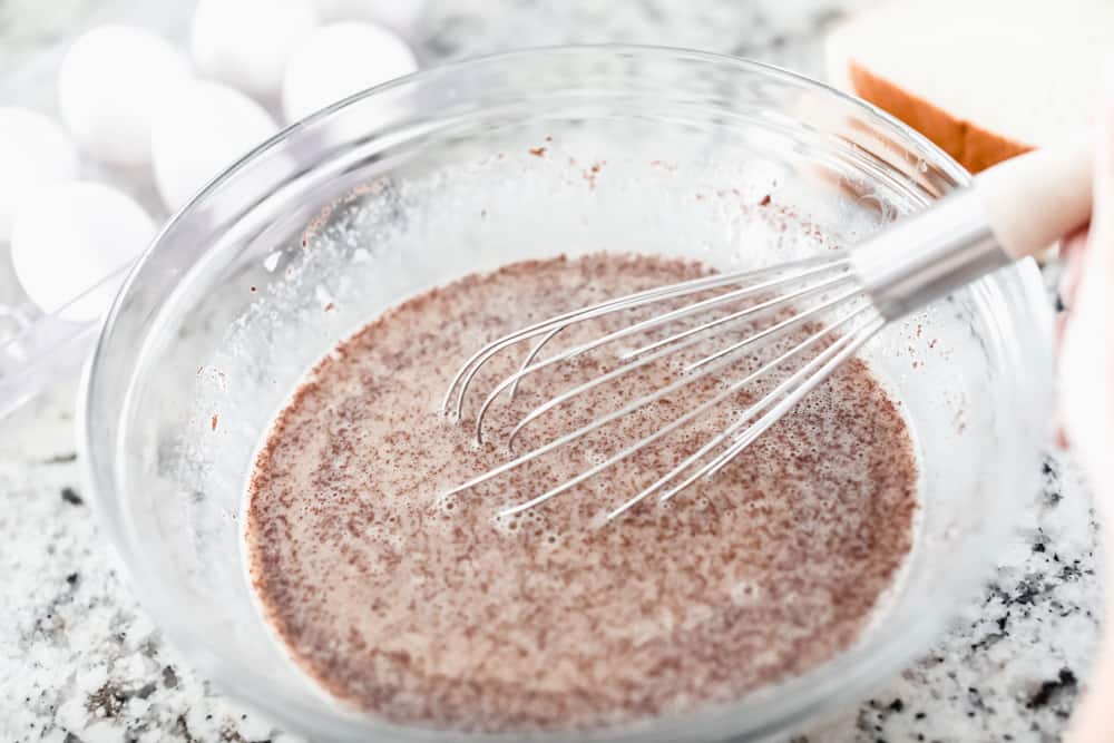 French Toast is a sliced thick, chunky bread dipped in a creamy egg, milk and cinnamon mixture with a secret ingredient that will take this French toast over the top! A little slice of heaven on your plate! Whisking the egg mixture together