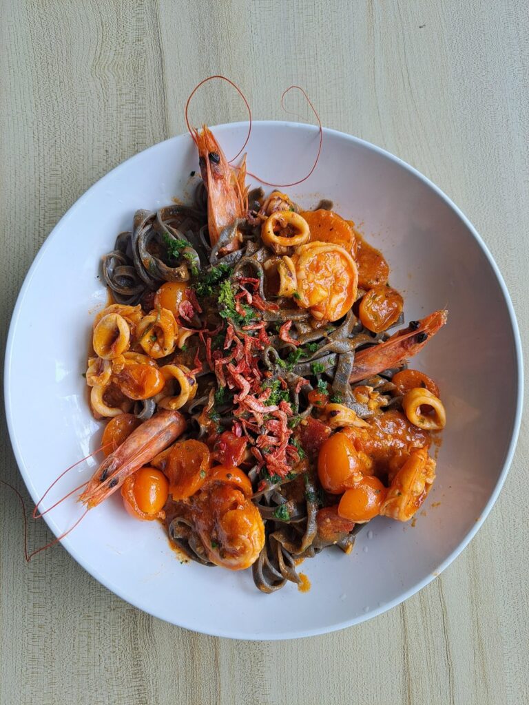 [I ate] handmade squid ink tagliatelle pasta with seafood marinara