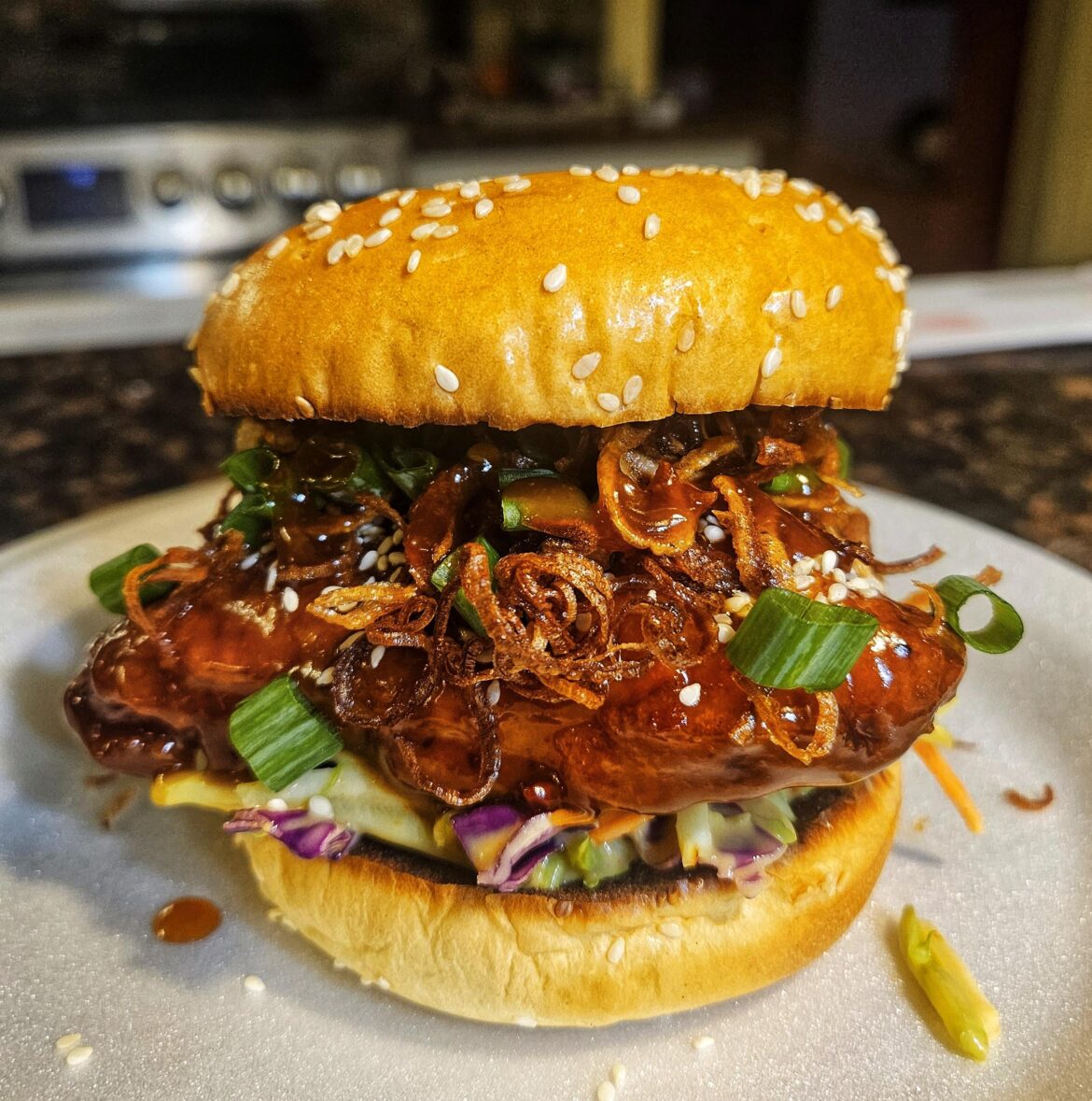 General Tso's chicken sandwich with broccoli slaw and crispy shallots.
