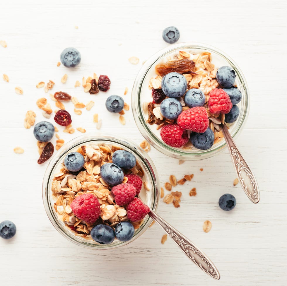 Granola with berries and yogurt in jars.