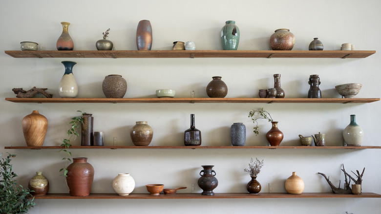 Shelves full of stoneware crocks and vases